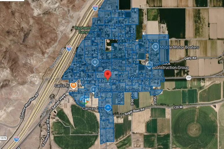 Satellite map of Elsinore between I-70 and the farm fields, with the town's streets shaded blue.