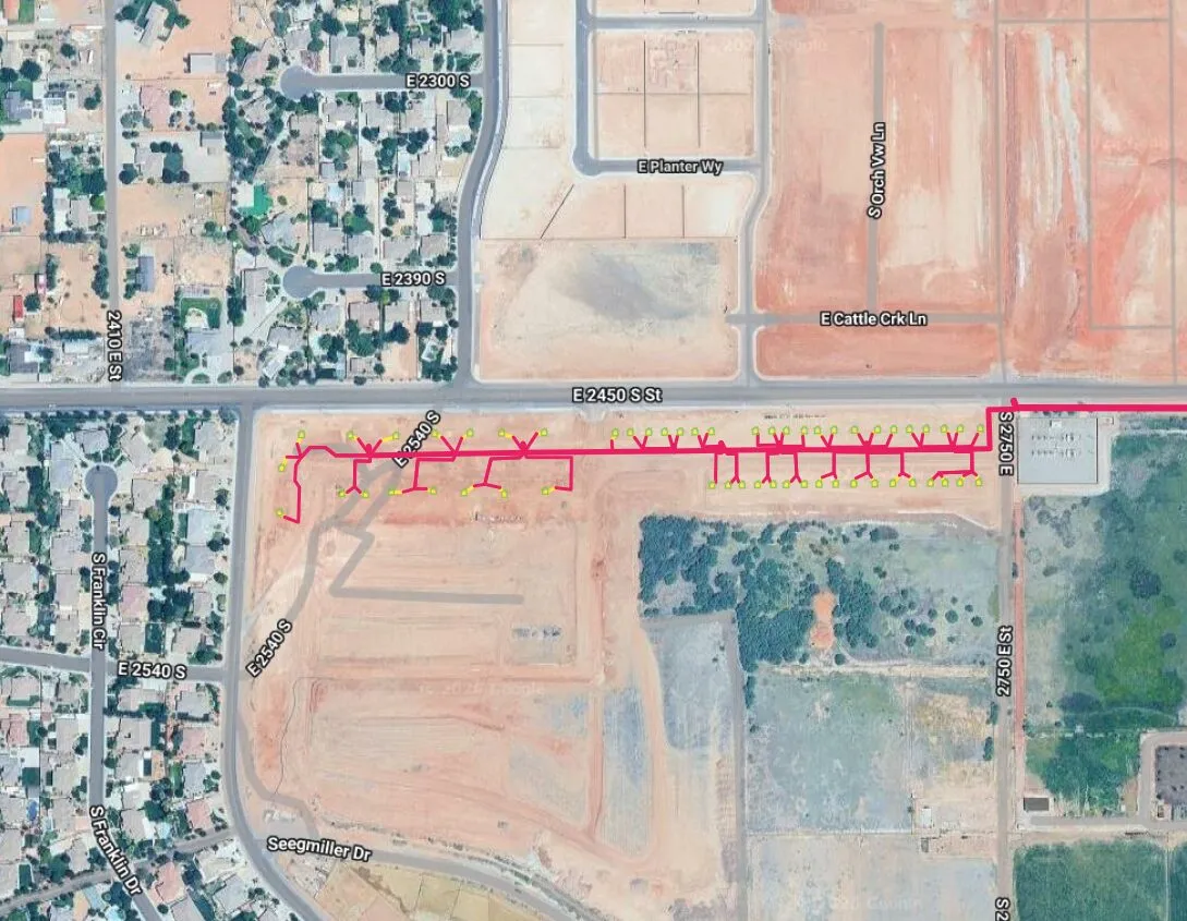 Satellite view of the Suniva construction site, the fiber route drawn as a pink line branching to lots along a new street.