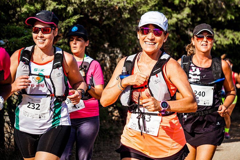 Runners smiling as they compete in a Southern Utah trail race