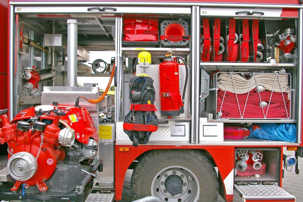 Rescue tools and hose lines loaded in a fire engine's side compartments